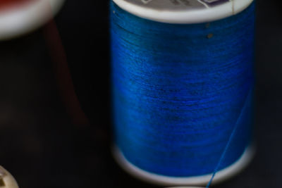 Close-up of blue cup against black background