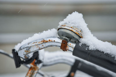 Close-up of snow on bicycle during winter