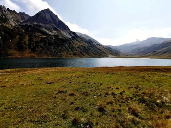 Scenic view of lake and mountains against sky