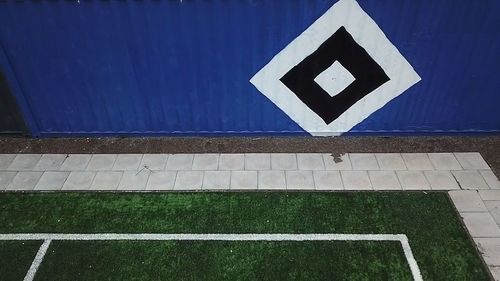 High angle view of road sign on wall