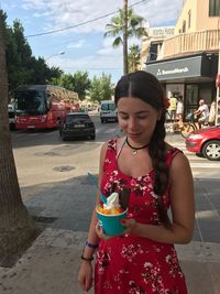 Young man eating ice cream outdoors