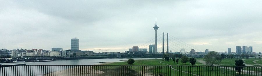 City skyline against cloudy sky