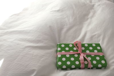 High angle view of gift box on bed