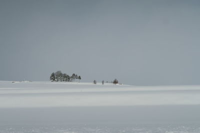 Scenic view of snow covered land against sky