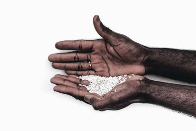 High angle view of person hand against white background