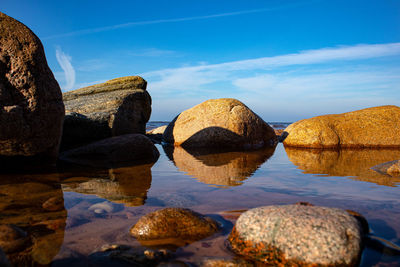 Rocks in sea against sky