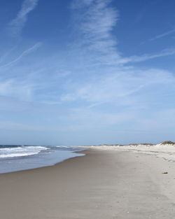 Scenic view of beach against blue sky