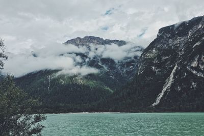 Scenic view of wet mountain against sky