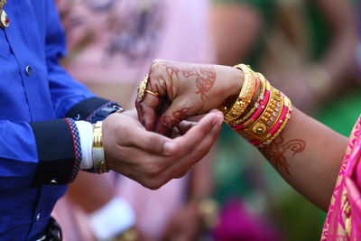 Midsection of couple holding hands