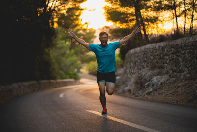 Full length of woman running on road