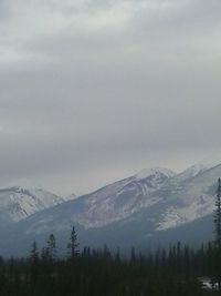 Scenic view of mountains against cloudy sky