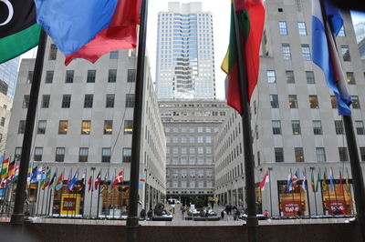 Flags by street amidst buildings