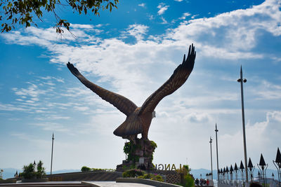 Low angle view of statue against cloudy sky