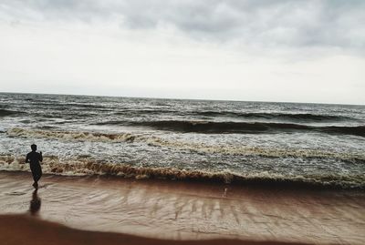 Man looking at sea against sky