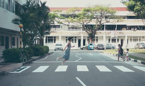 People walking on street against buildings in city