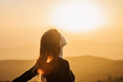 Portrait of woman against sky during sunset