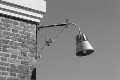 Low angle view of electric lamp on wall