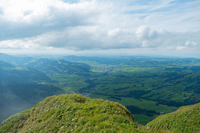 Scenic view of green landscape against sky