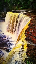 View of water flowing through rocks