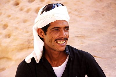 Close-up of mid adult man wearing turban at desert