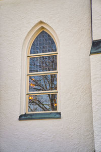 Low angle view of window on wall of building