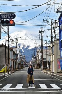 Rear view of man walking on railroad station