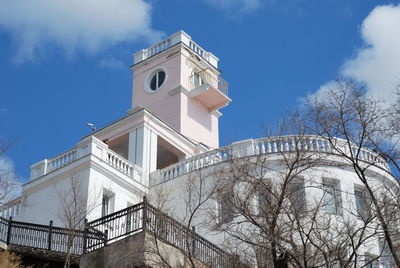 Low angle view of building and trees against sky