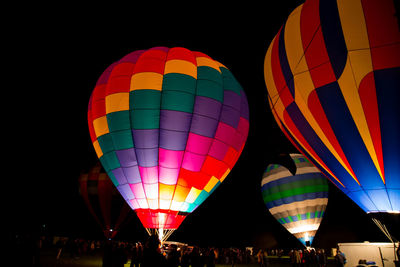 Low angle view of hot air balloons at night