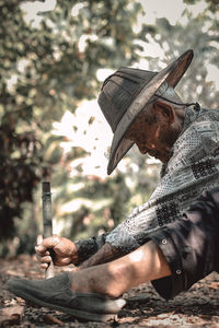 Portrait of man holding leaf outdoors