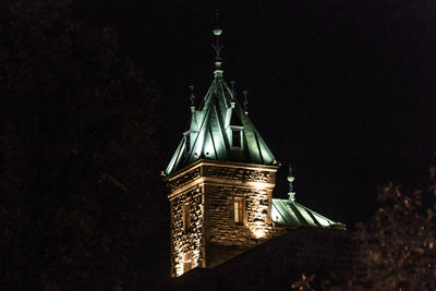 Low angle view of illuminated building against sky at night