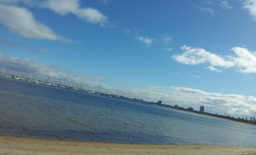 Scenic view of beach against blue sky