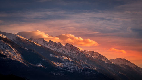 Scenic view of snowcapped mountains against sky during sunset