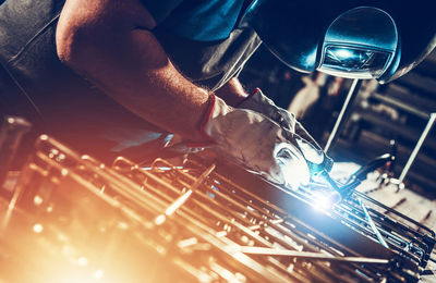 Midsection of man welding in workshop