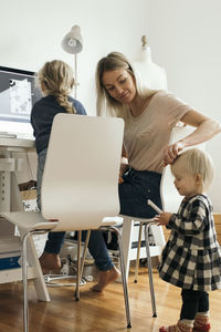 Female design professional with daughters at home