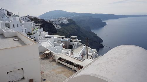 High angle view of townscape by sea against sky