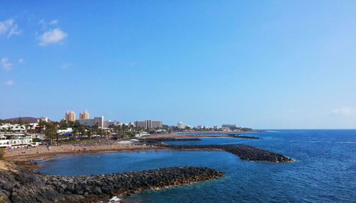 View of cityscape against blue sky