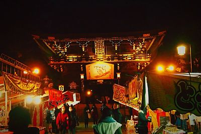 People in amusement park at night