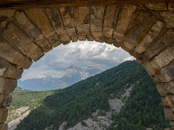 Scenic view of mountains against cloudy sky