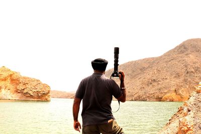 Rear view of man standing against sky