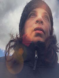 Close-up portrait of mid adult man against sky