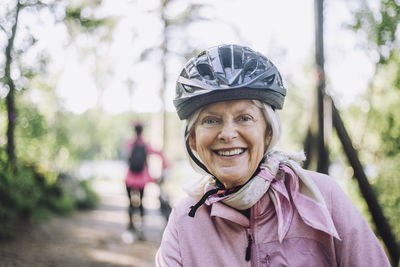 Portrait of happy senior woman wearing cycling helmet