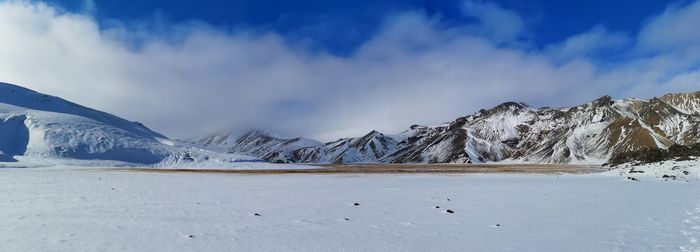 Scenic view of snowcapped mountains against sky