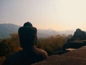 Rear view of a buddha statue on mountain