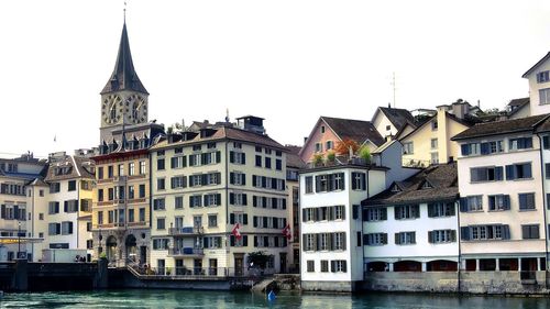 View of buildings in city against clear sky