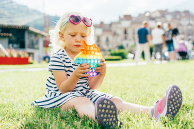  a child girl presses with her fingers the bubbles of antistress simple dimple.