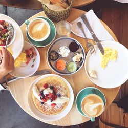 Cropped image of woman having food at table