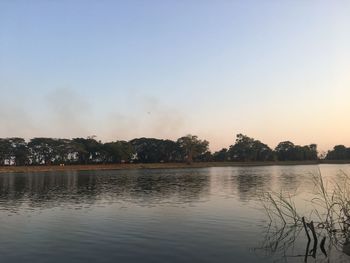 Scenic view of lake against sky at sunset