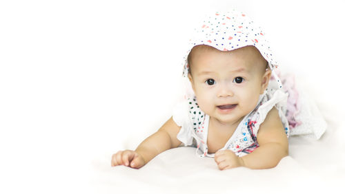 Portrait of baby girl against white background