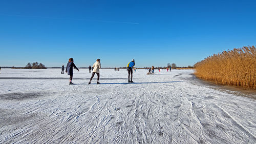 Ice skating on a natural frozen lake in the countryside from the netherlands