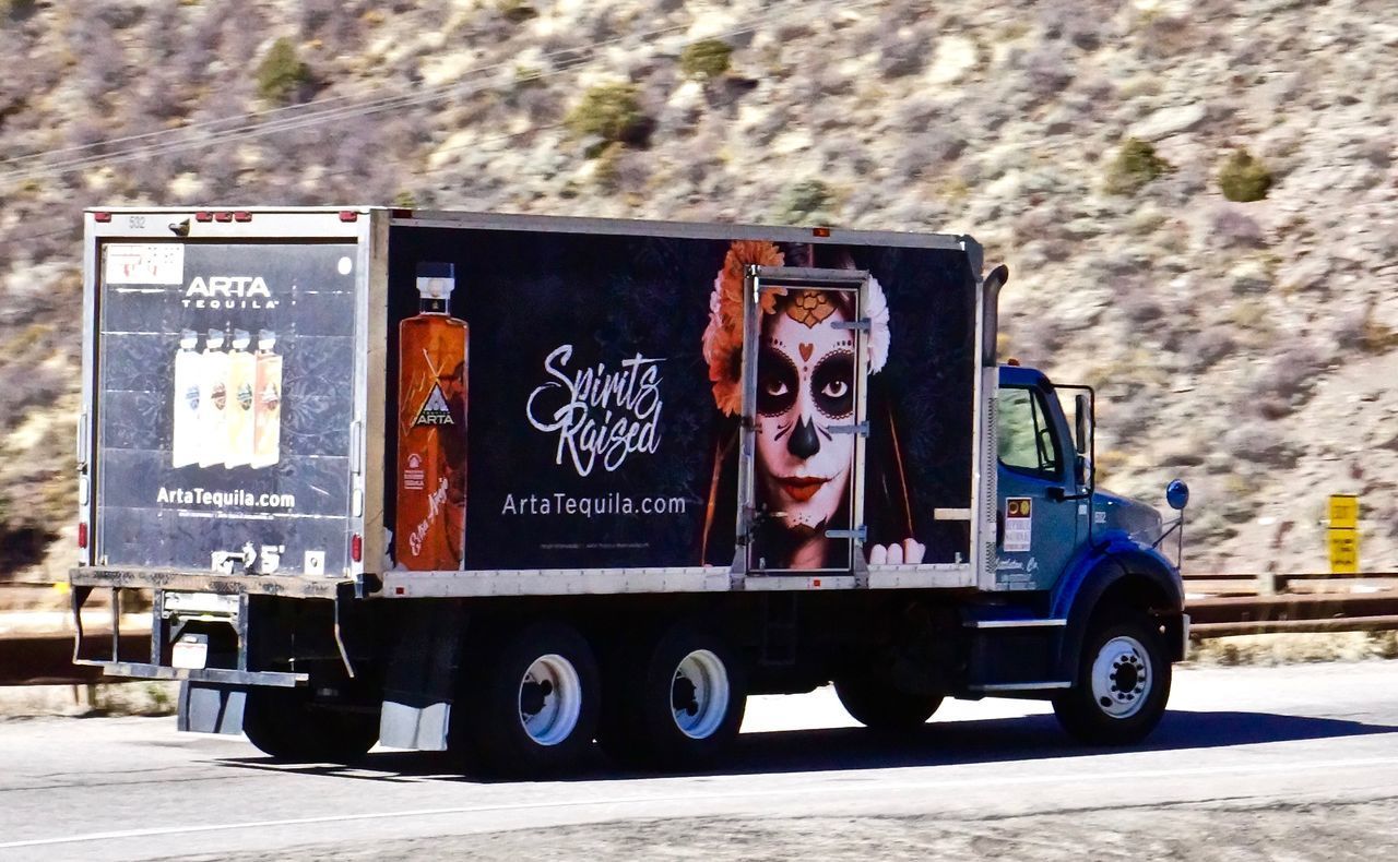 VIEW OF TRUCK ON ROAD AGAINST WALL